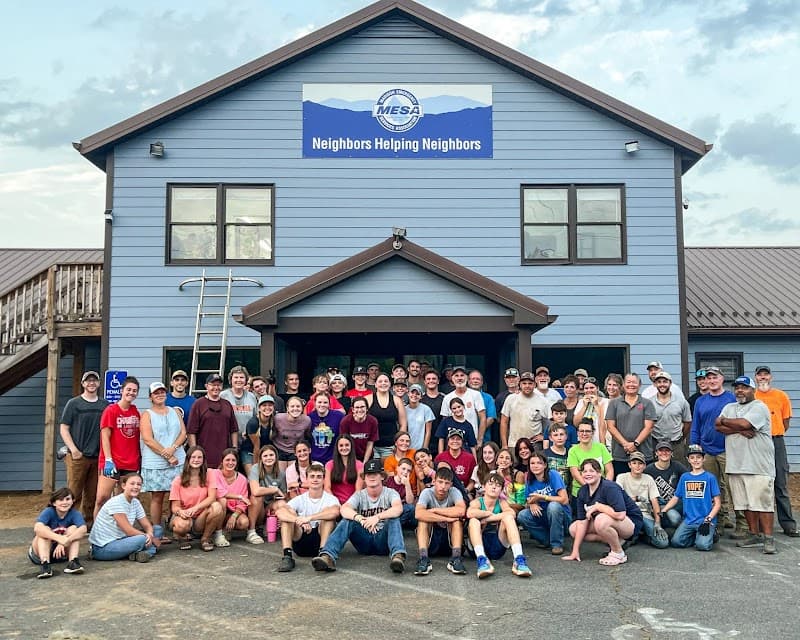 Volunteers pose for group photo in front of the MESA building.